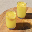 Load image into Gallery viewer, Iced turmeric drink made from the turmeric Blume blend.
